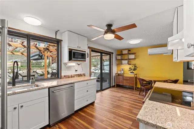 This bright and airy kitchen is perfectly set up for indoor/outdoor dining and entertaining. (The big sliding window by the sink makes a convenient pass through!)