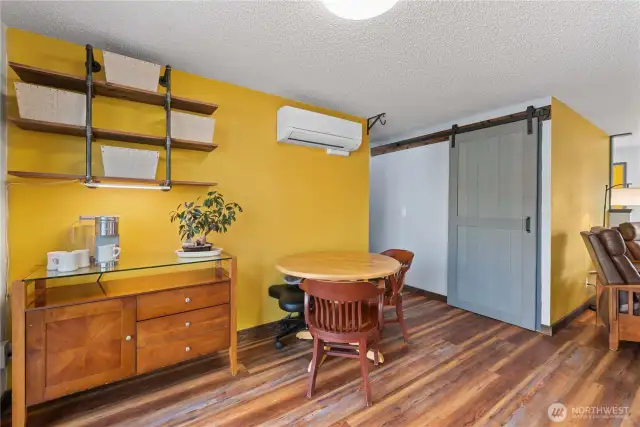 The owners don't need a large dining table, but there is space for one.  Notice the barn door in the background ...