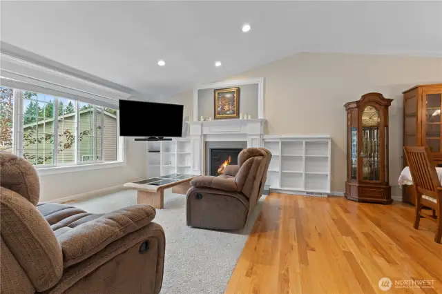Living room w/brand new carpet, gas fireplace w/custom mantel & book shelf surrounding