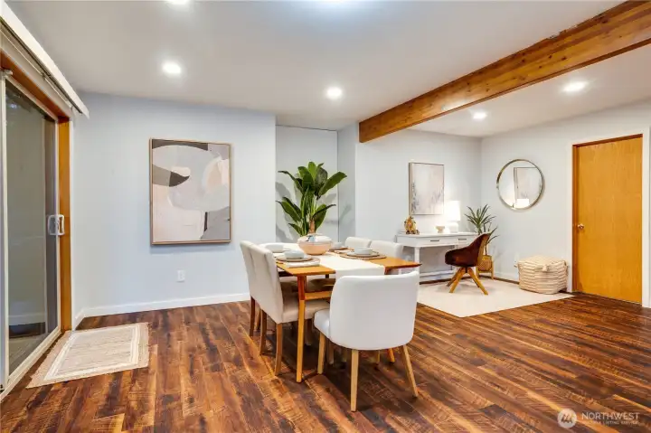 A welcoming entry flows into dining and flex space, accented by rich woods and natural light.