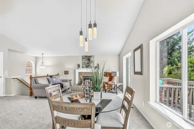 From the dining area, the full great-room comes into view—light-filled, vaulted, and designed for easy circulation. Proximity to the deck encourages al-fresco dining and relaxed evenings.