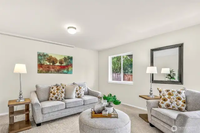 Daylight windows keep the lower-level gathering space bright year-round. Durable finishes and open dimensions support multiple zones for relaxing, work, and hobbies.