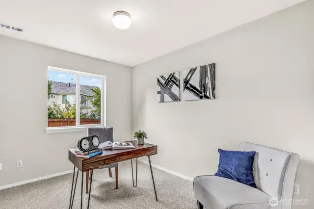 Flexible lower-level bedroom or quiet home office with new carpet and interior paint. A large window brings in natural light and backyard views—ideal for focused work, study, or guest accommodations.