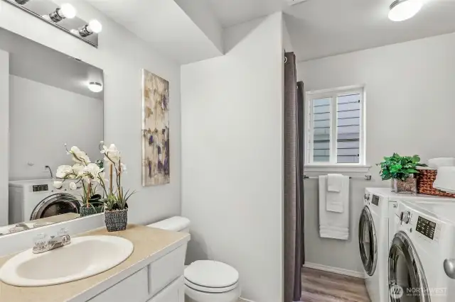 Convenient lower-level three-quarter bath combined with laundry. New LVP flooring, a window for ventilation, and practical storage make day-to-day living simple—great for guests, multi-gen use, or post-play cleanup.