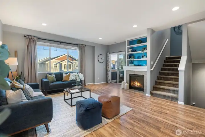 Open concept main living full of light and hardwood flooring.