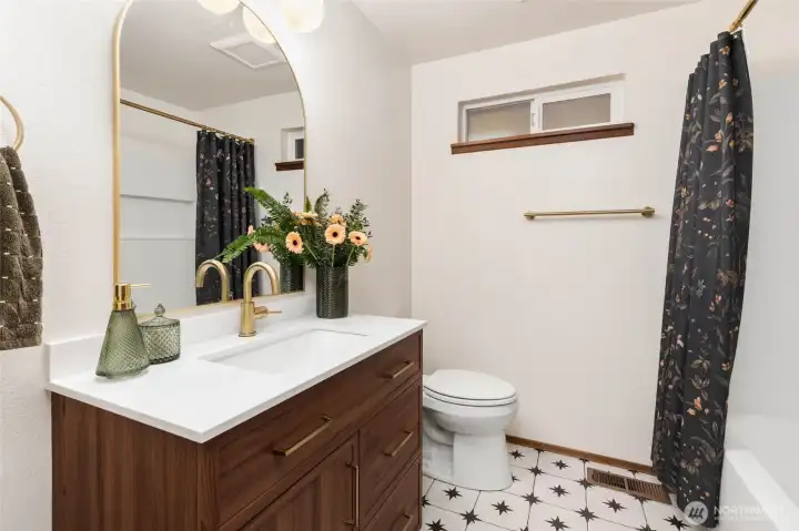The main floor full bathroom was fully remodeled in 2025 and features gold fixtures.