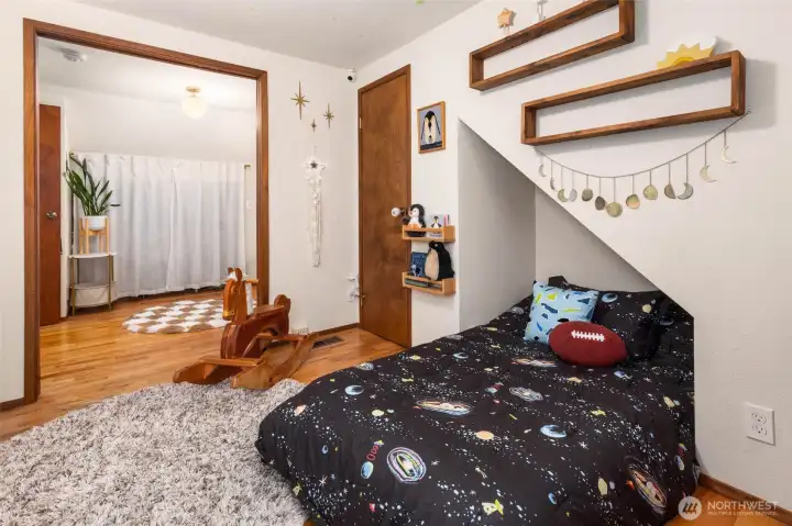 Pocket doors between two of the upstairs bedrooms can open up to create one larger room or a bedroom with office/attached playroom.