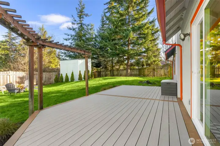 A trellis and cafe lighting frame part of this expansive entertaining deck.