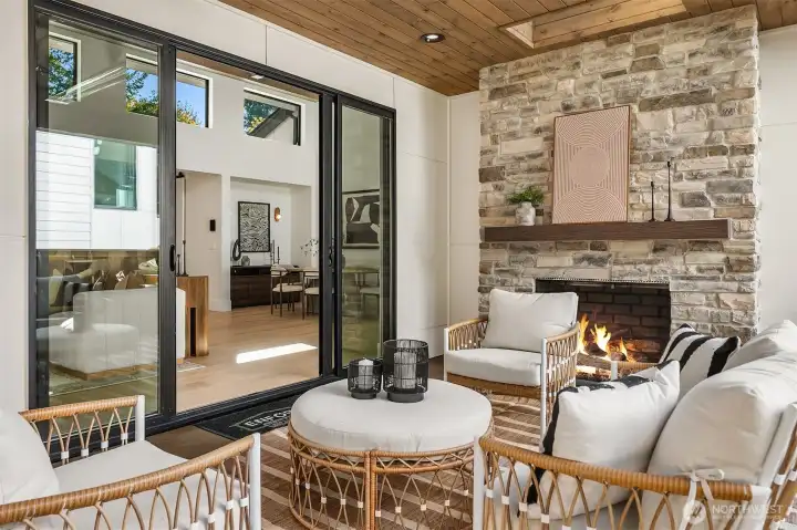 Effortless indoor-outdoor entertaining through sliding double doors, with a patio heater for cozy year-round gatherings