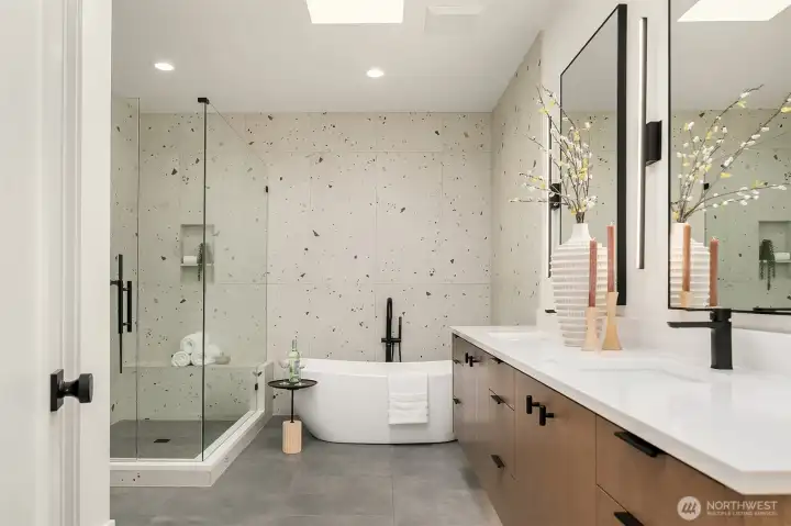 A spa-inspired bath featuring heated floors, toe-kick lighting and natural light streams from skylight.