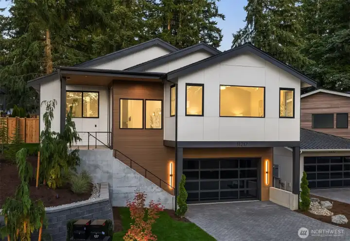 Thoughtfully designed landscaping and curb appeal provide a striking first impression.   2-car garage with EV charger provides modern convenience.