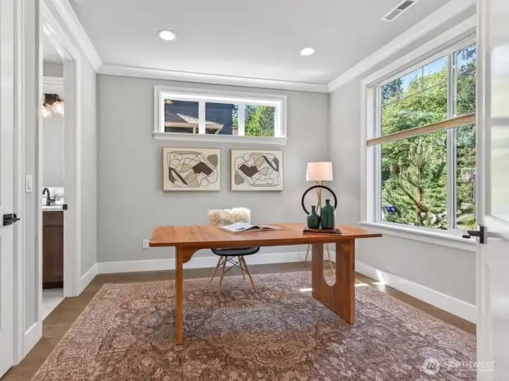 Main level guest suite offers flexibility for visitors, multi-generational living, or home office.