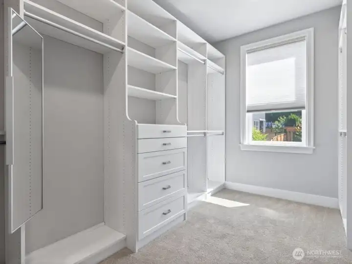 primary suite features DUAL walk-in closets