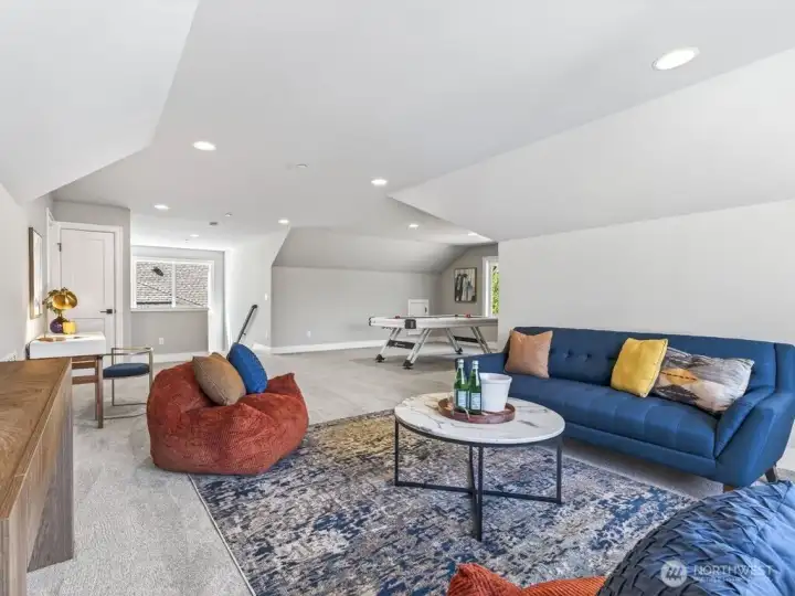 The enormous rec room offers exceptional versatility for media, fitness, theater, play, entertaining, or additional office space.