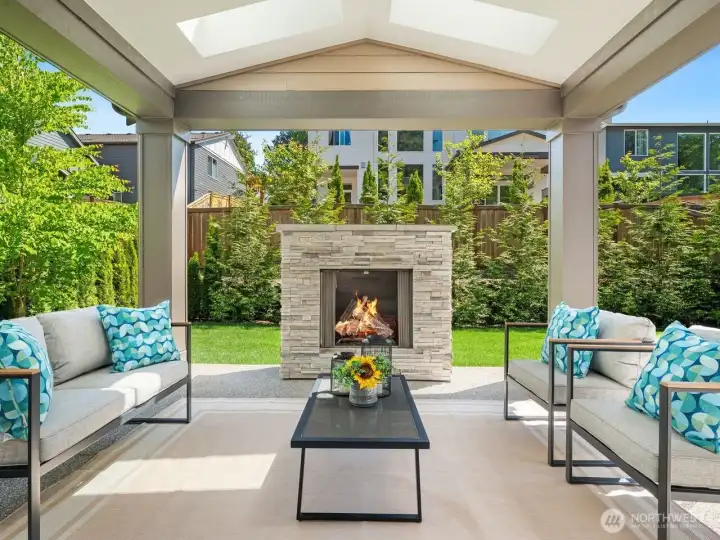 Enjoy year-round outdoor living on the covered patio complete with skylights and a gas fireplace, all overlooking the expansive level fully fenced green backyard.