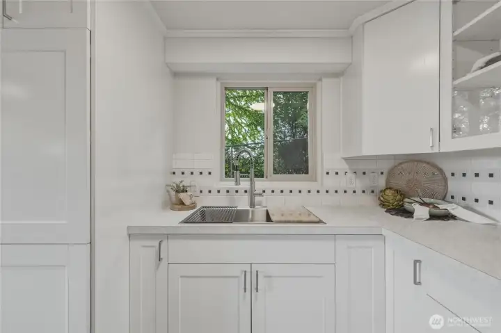 The cabinet to the left of the sink is where you'll find the washer & dryer.