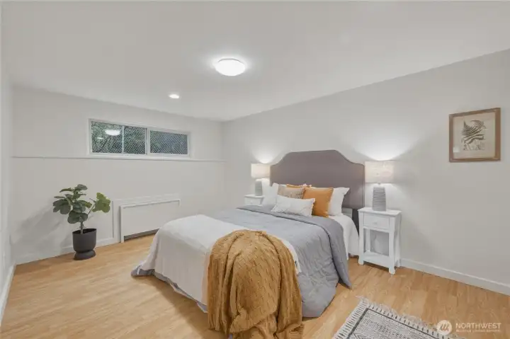 A spacious and peaceful bedroom with room for additional furniture, offering a calm retreat tucked away from the main living spaces.
