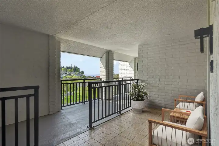 Staged-Welcoming covered entry w/patio & views of the park & water.