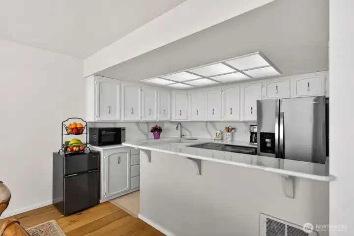 Beautifully updated kitchen with new stainless appliances and Qaurtz countertops and backsplash.
