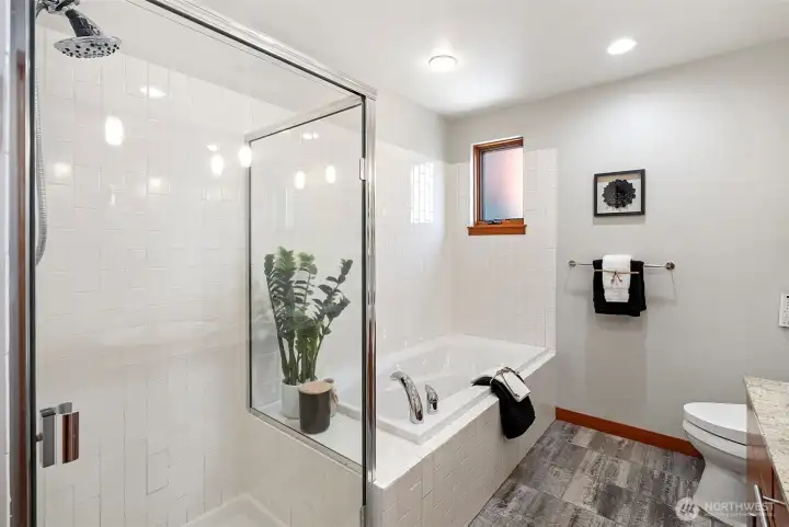 Primary bathroom features separate tub and shower