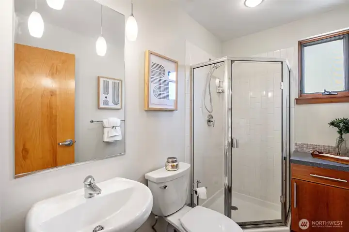 Hall bathroom with shower and linen storage