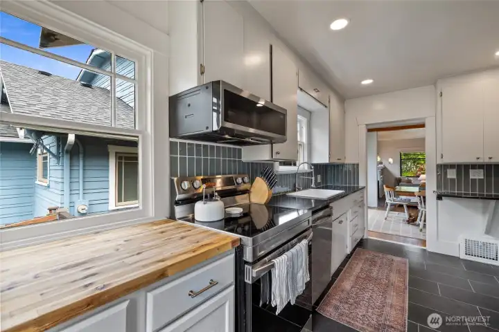 Remodeled in 2025, this kitchen offers stylish tile backsplash, farm sink, and additional butcher block counters.