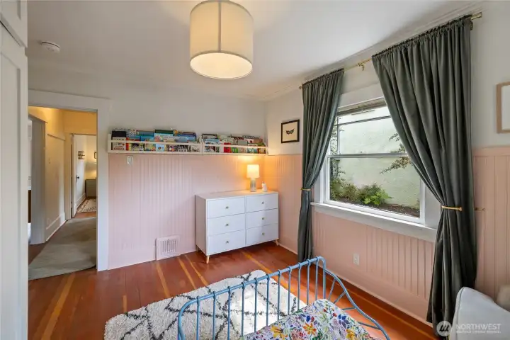 Fir floors underfoot in both main floor bedrooms, wainscoting and original windows adds to the charm of this room.