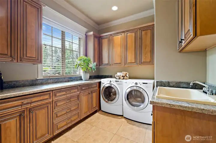 Huge laundry with lots of storage cabinets w/ sliding drawers Huge laundry with lots of storage cabinets w/ sliding drawers