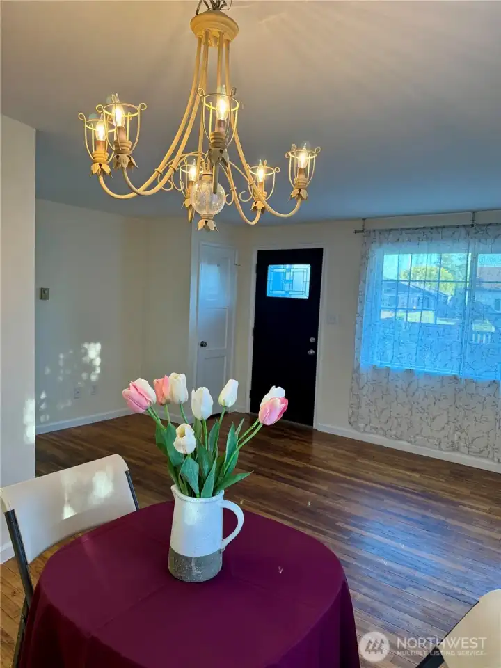 Standing in the dining area looking at the living room and entry door.