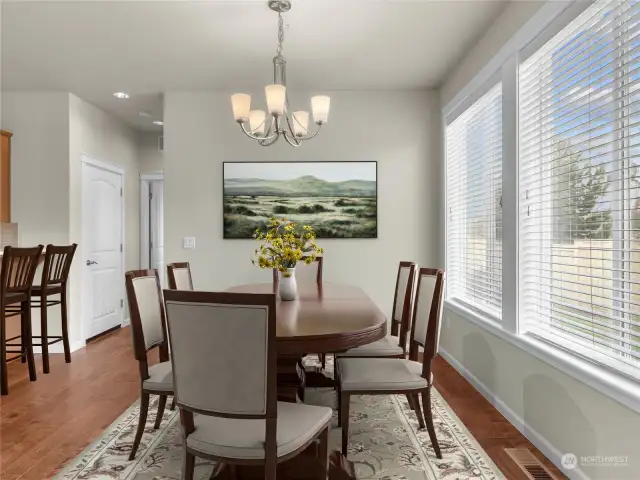 Spacious dining area with views of the back yard. Virtually staged.
