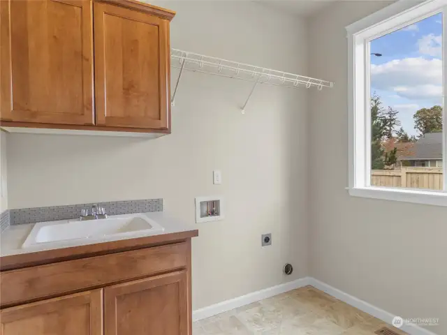 Laundry room with convenient utility sink.