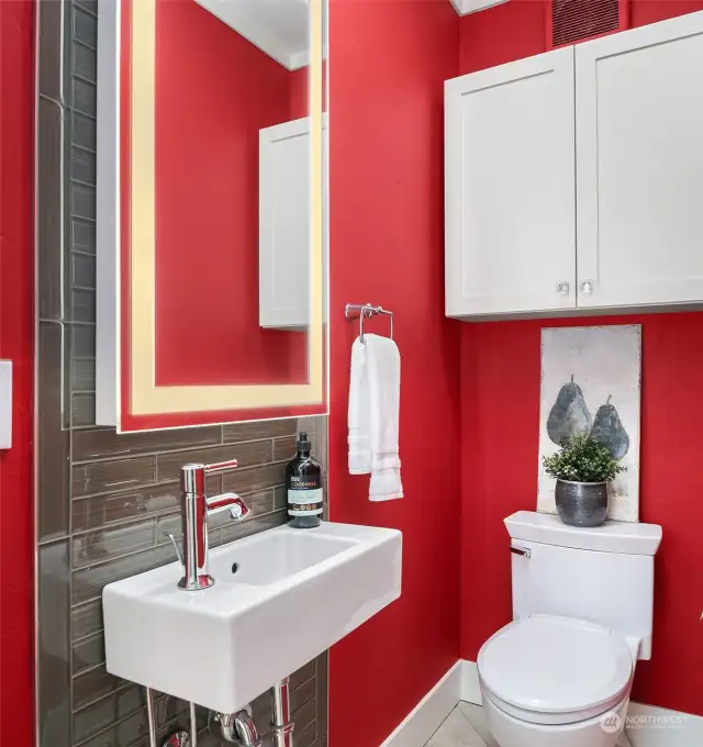 The main floor includes a colorful 'powder room' adjoining the living room with heated floor and toilet seat.