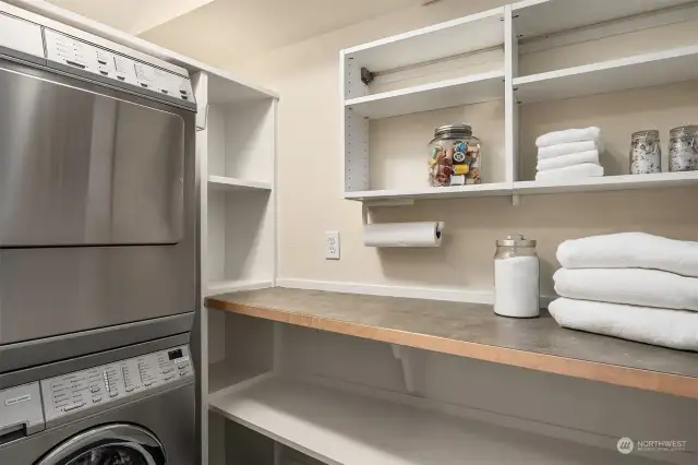 The lower level includes a Miele laundry stack, built in cabinets and shelving perfect for a pantry!