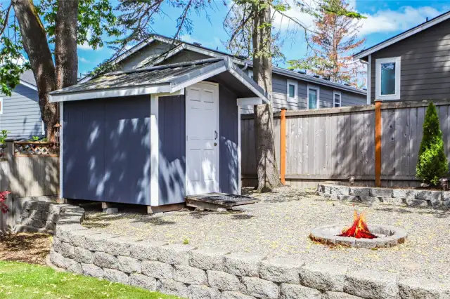 Block retaining wall with gravel firepit area   Garden / Storage shed
