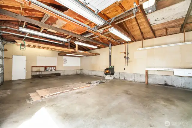 3 Car DETATCHED SHOP/ GARAGE   3 - 9’ Tall garage doors / Opener   10‘ Ceiling height, plus rafter storage  12’ x 10’ loft storage shelf with ladder