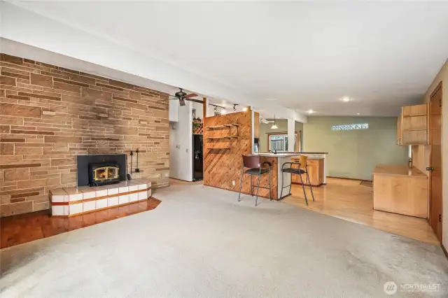 Sandstone faced wall, with wood burning fireplace and tile raised hearth  Wood décor wall