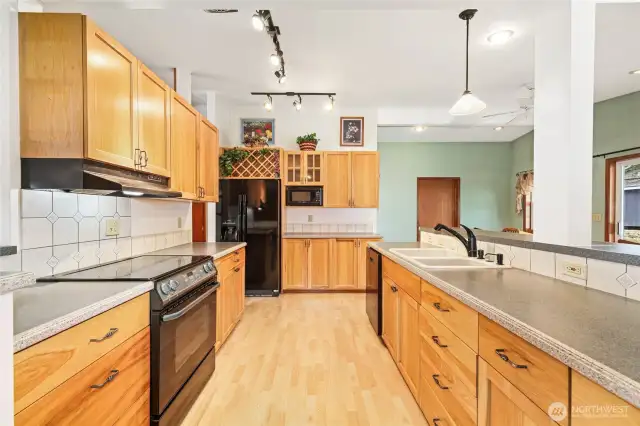 KITCHEN  Hickory wood cabinets  Wilsonart laminate counter tops with Gilbratar solid surface edge  Tile backsplash