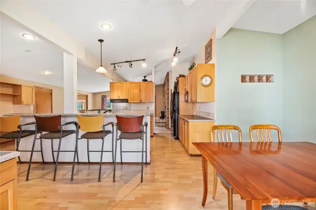 Long eating bar with bar stools  Glass blocks allow for natural light   Dual desk with upper cabinets and works well as a buffet  Ceiling fan / Recessed lighting  Laminate floor  Doors to utility room & rear yard