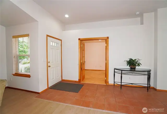 Living showing front door and entry to den