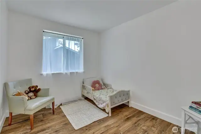 Secondary bedroom  has vinyl plank flooring, mirrored closets, fresh paint.
