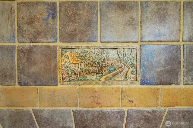 Period Batchelder Tile surrounds the fireplace.