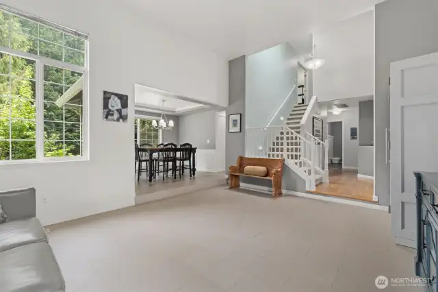 Oversized living room/flex room with vaulted ceilings and durable tile flooring.