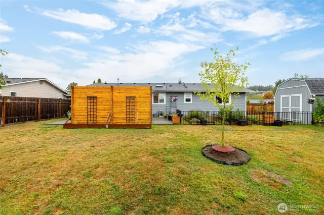 Back of the home and privacy wall. You can see the 10x10 barn shed with storage loft