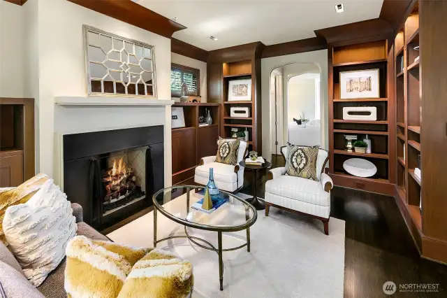 A close up view of the fireplace and custom built-in bookcases lining the walls.