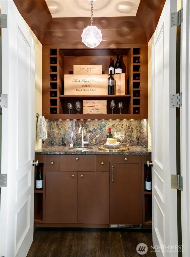 A wet bar is quietly located between the sitting room and the more casual dining/living room.