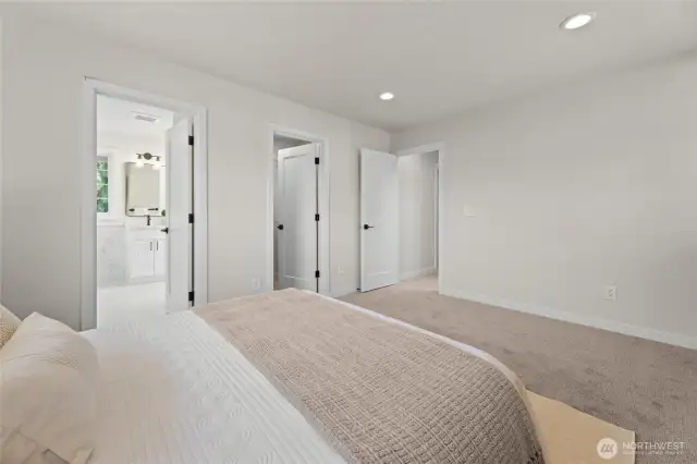 View of primary bathroom entry and walk in closet