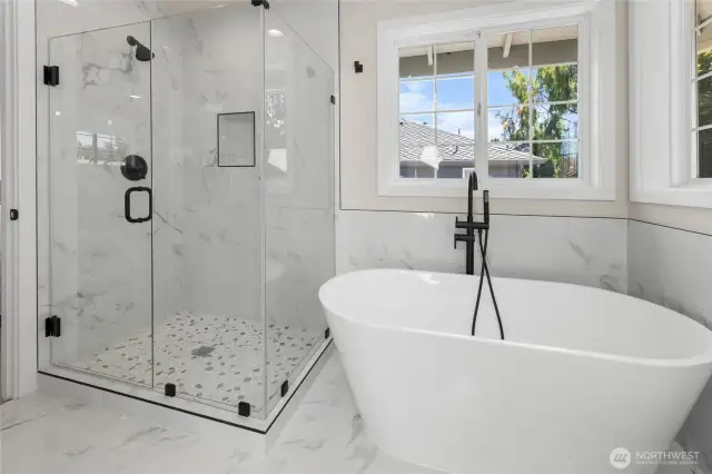 Freestanding soaker tub with fully tiled shower