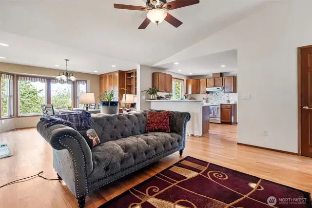 Another view of the family room from the laundry room entry looking into the kitchen and the generous breakfast nook with more gorgeous built ins and a work desk overlooking the patio and back yard.