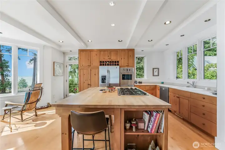 Enjoy breakfast around the large butcher block countertop island.