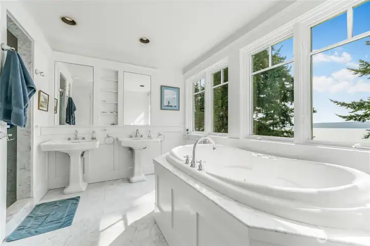 The primary bedroom’s 5-piece ensuite complete with a jetted tub, two sinks and shower.